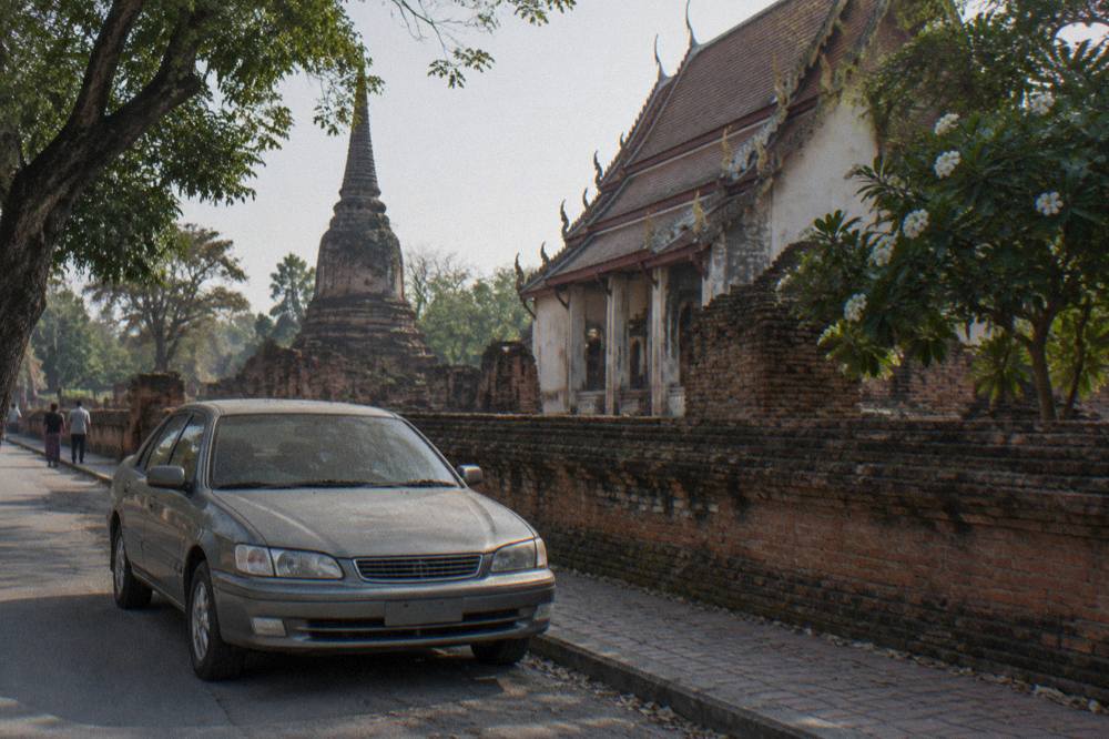 A taxi waiting on a Bangkok side street in morning light