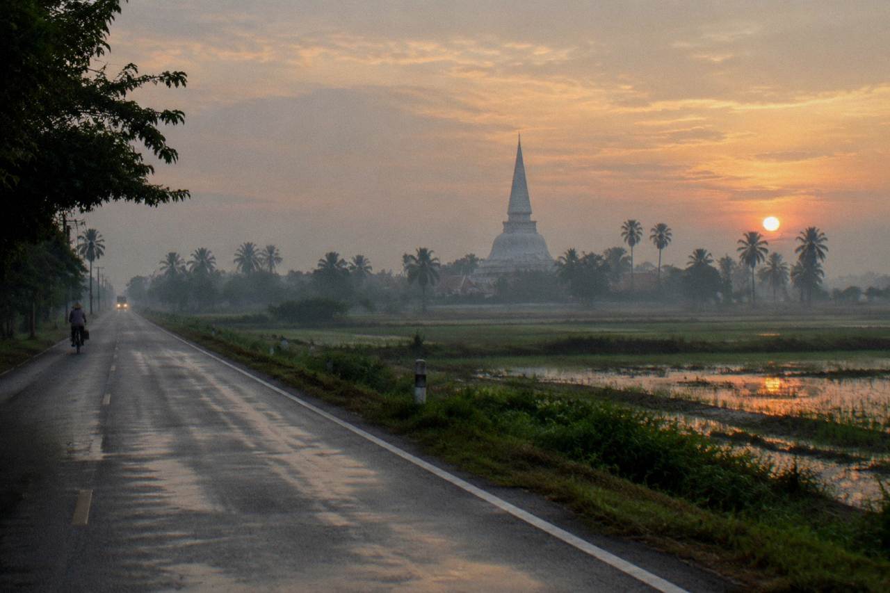 A road heading north from Bangkok toward temple spires on the horizon