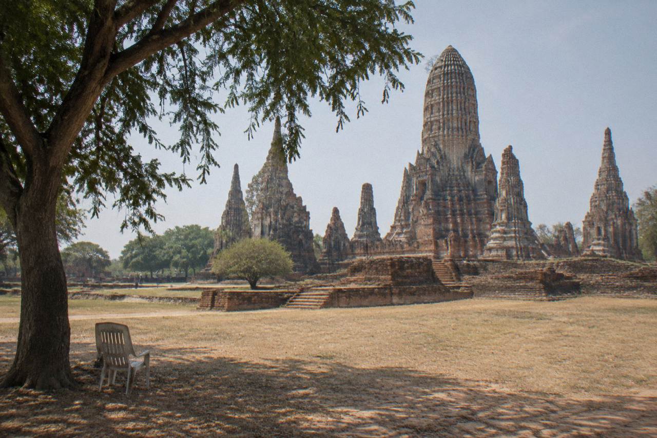 Ancient brick temple ruins standing in open grassland under a wide sky