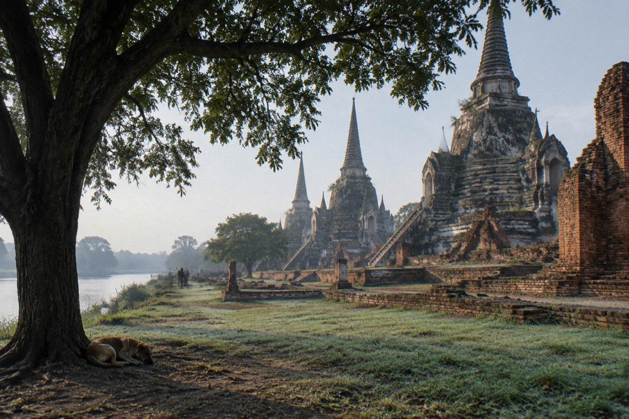 Morning light over red brick temple ruins beside a river in Ayutthaya