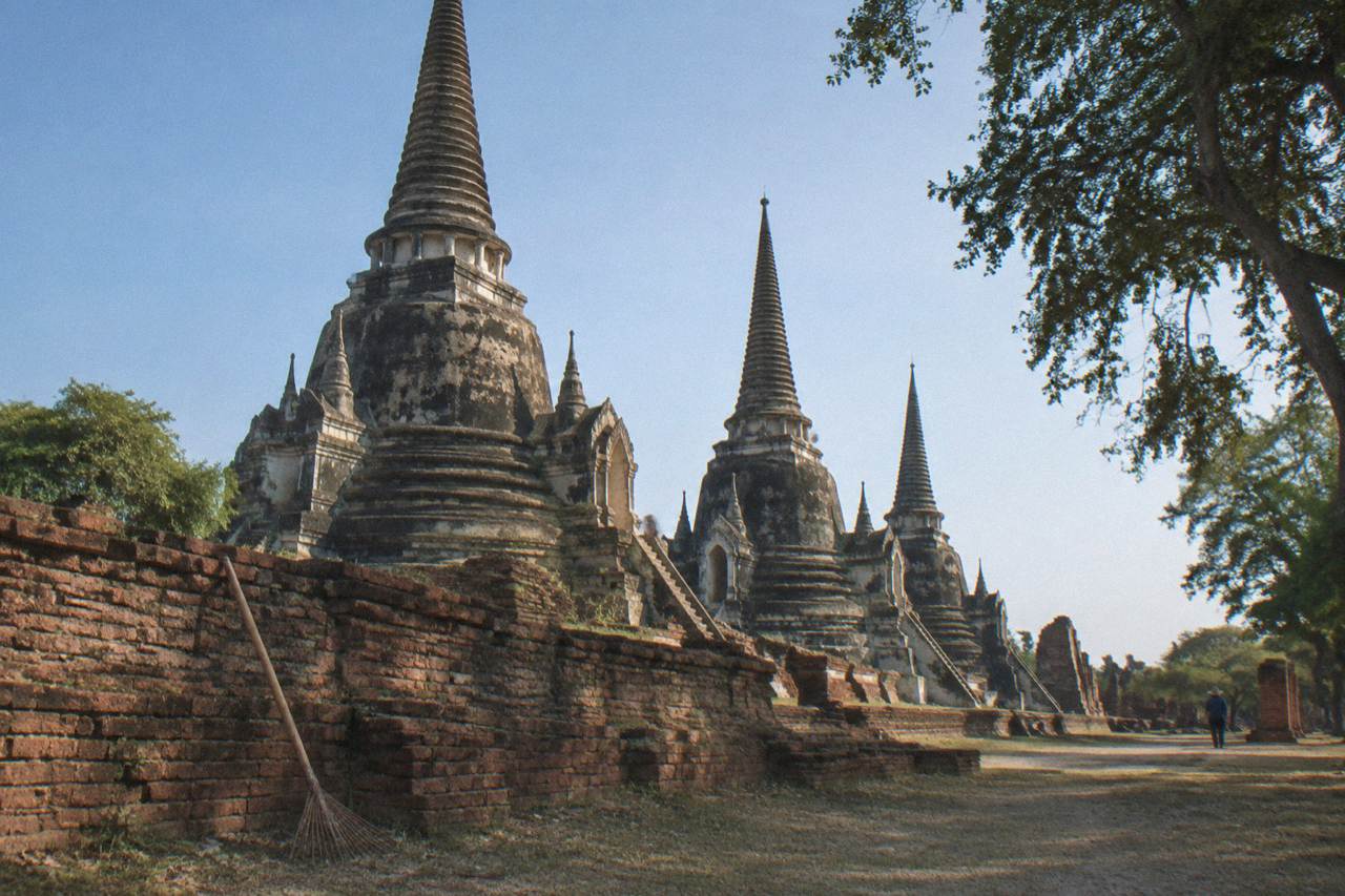 Ancient brick prangs and monastery ruins of Ayutthaya under a clear morning sky