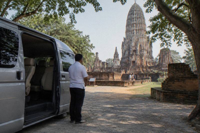 Private guide leading a small group through an ancient Ayutthaya temple on a private day tour of the historical park