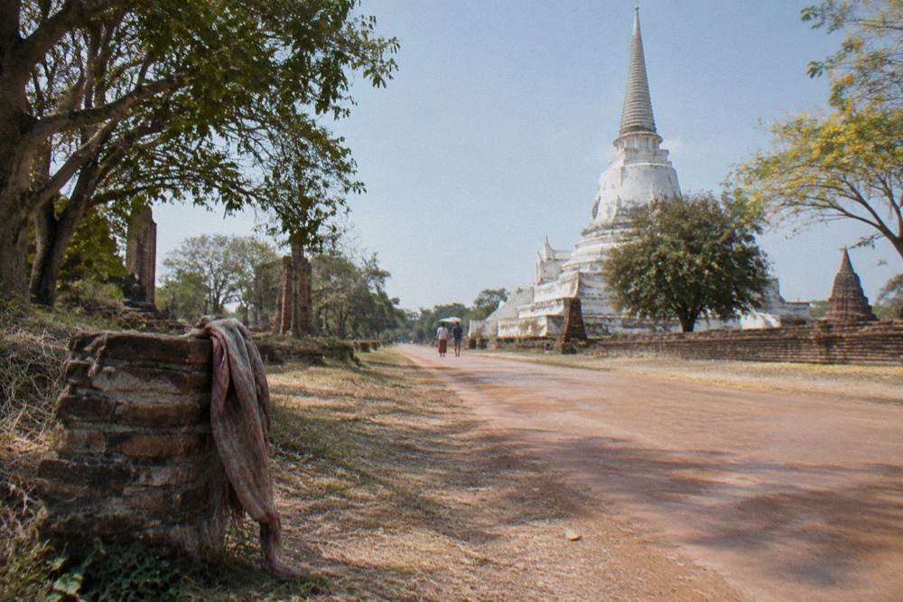 Bicycles parked beside a brick stupa on a quiet road inside the historical park
