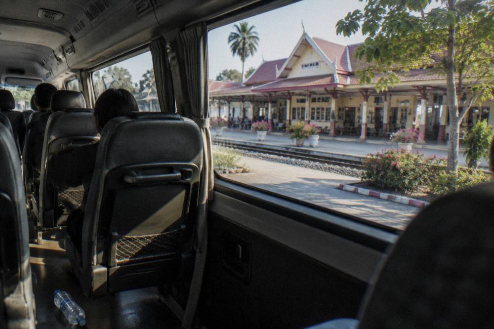Tour van interior with air-conditioned seats and morning light through the windows