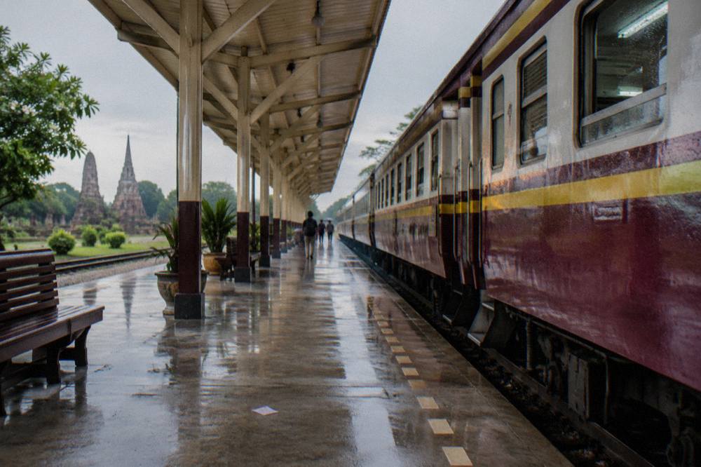 An air-conditioned commuter train standing at a Bangkok railway platform