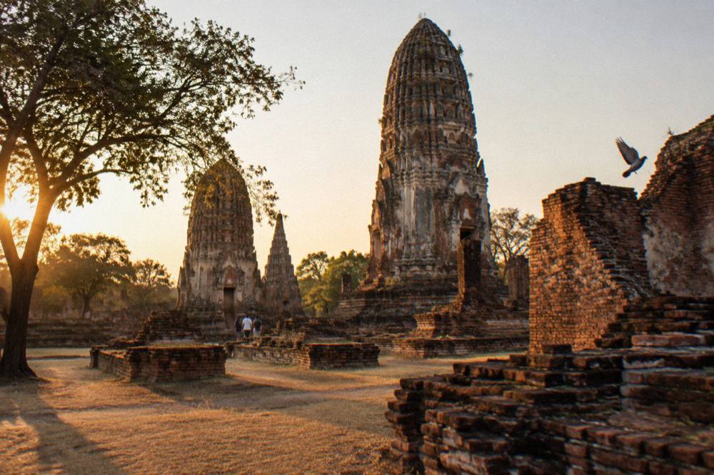 Golden late afternoon light on ancient brick ruins with long shadows