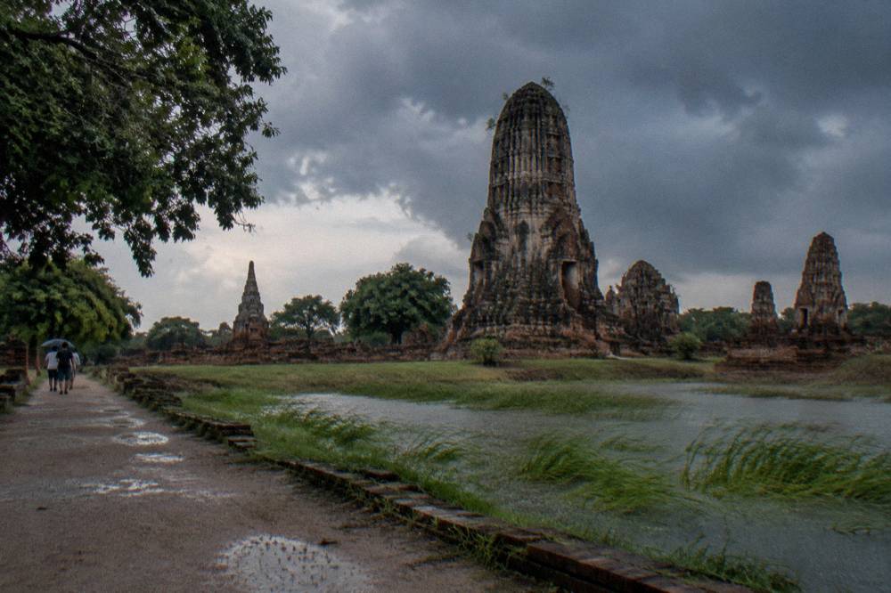 Tropical rain clouds gathering over temple ruins and open ground